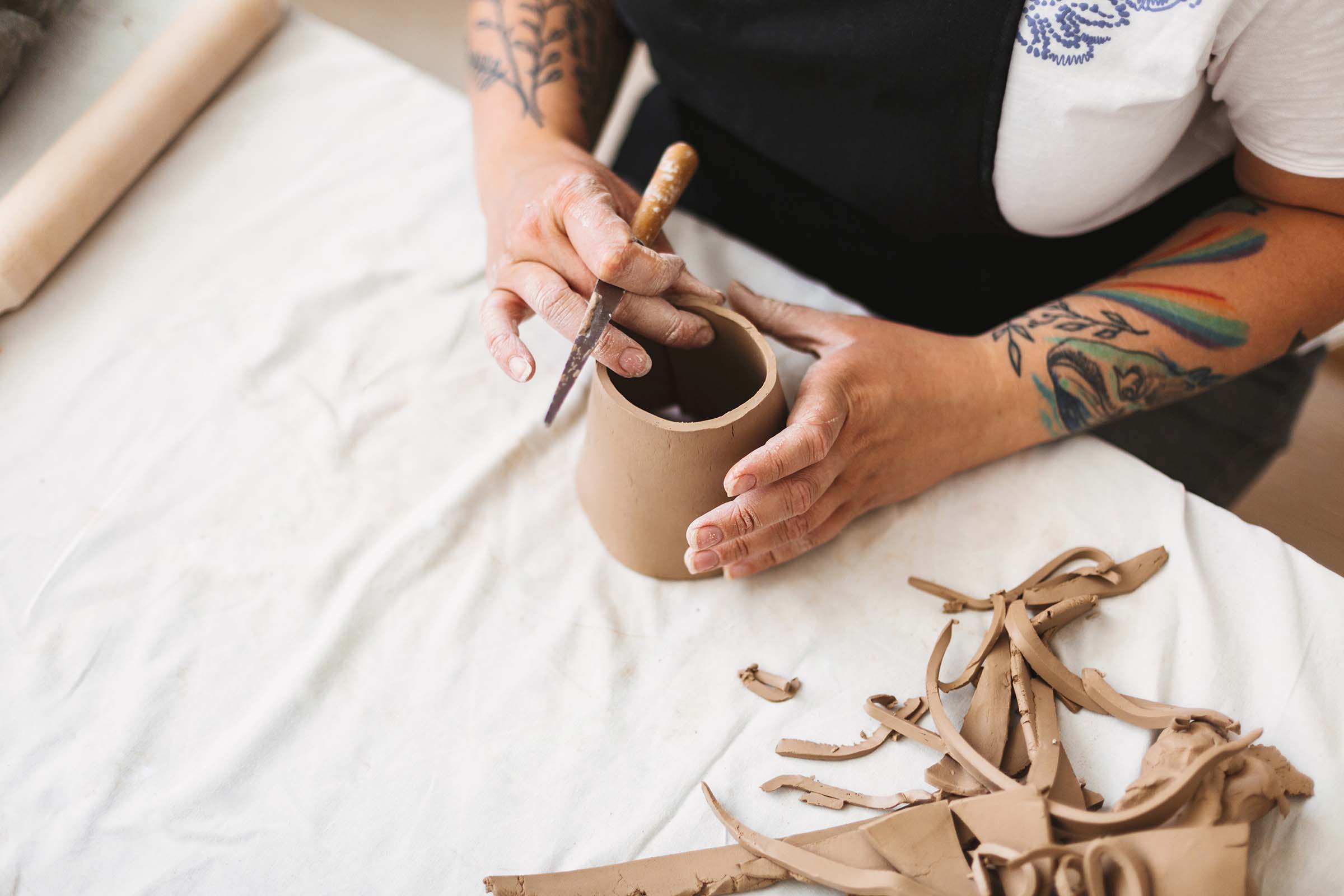 close-up-woman-hands-with-colorful-tattoo-working-8XVGL7M.jpg